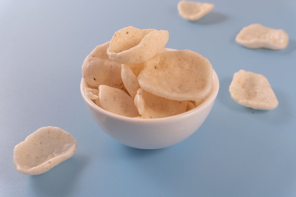 Crispy traditional crackers (kerupuk) served in a ceramic bowl