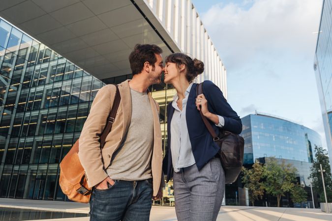 Businesspeople couple outside contemporary building