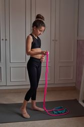 Focused sportive girl preparing to jump rope