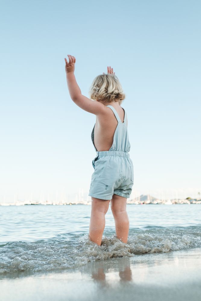Unrecognizable child standing in sea
