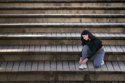 Young woman sitting on stairs