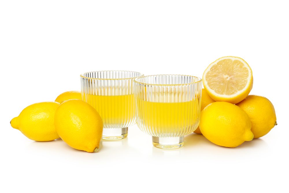 Limoncello, Italian lemon liqueur, isolated on light background