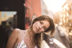 Woman against sunny blurred background