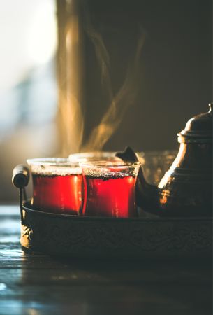 Hot brewed tea on tray with teapot
