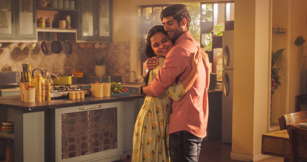 A Heartwarming Moment of Reunion: Young Couple Meet at Home and Greet Each Other with Warmth and Affection after Long Parting.