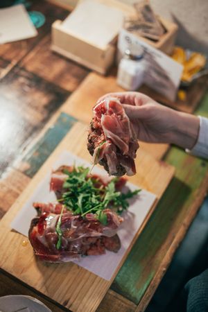 Person with toast and ham