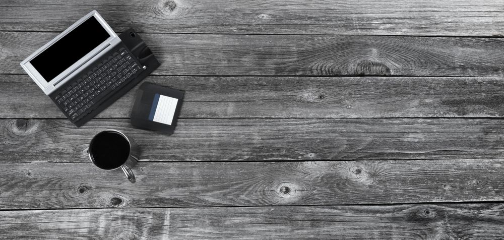 Tech vintage with coffee on old wood desk table