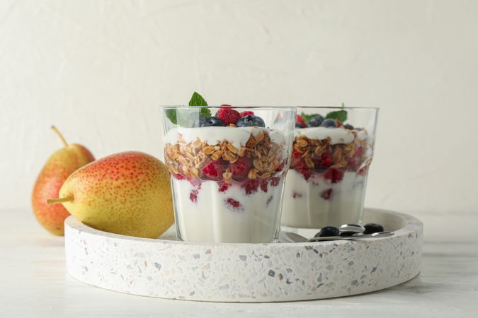 Parfaits and pears on wooden table, space for text