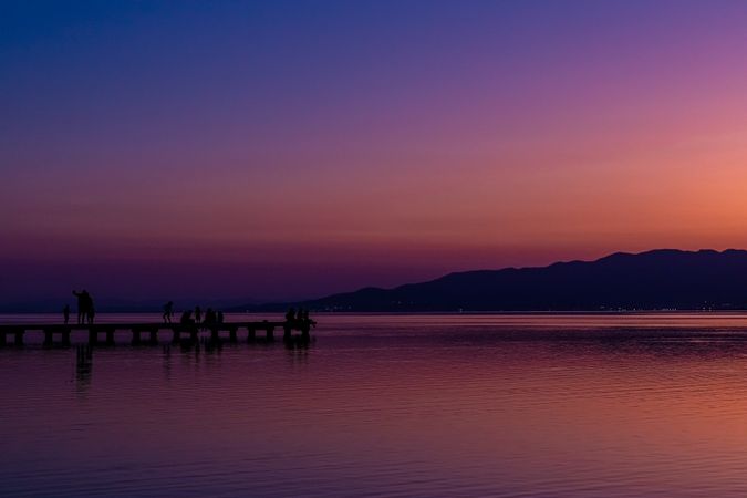 Sunset on a sea walkway with people