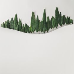 Green leaves in row on light background