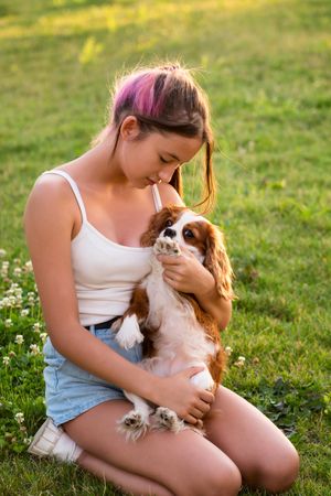Teen girl sitting with the dog
