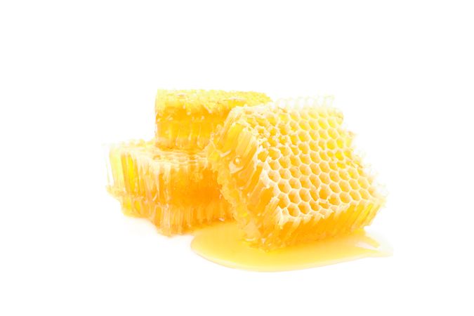 Pieces of honeycomb isolated on blank background, close up