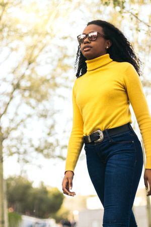 young Black woman walking in a park