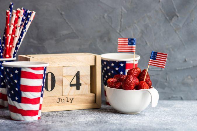 Bowl of strawberries with little USA flags for Independence Day with copy space