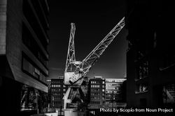 Grayscale photo of crane near building 41vANb