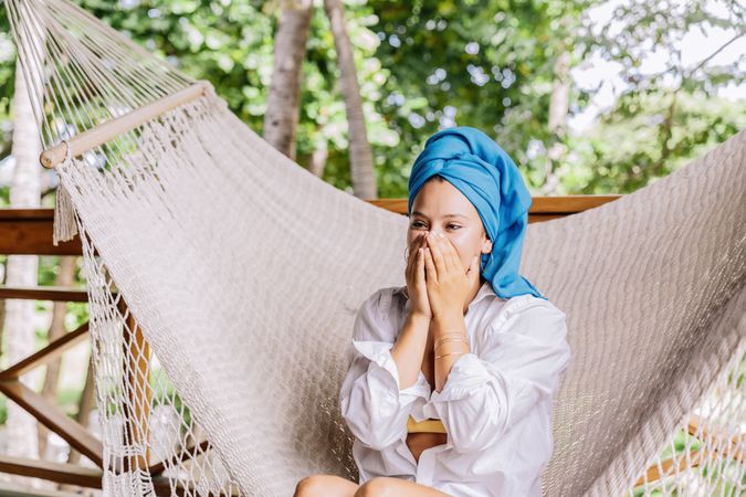 Woman in turban resting in hammock