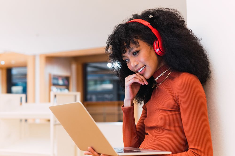 Female using laptop and listening to music