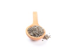 Chia seeds and wooden spoon isolated on plain background