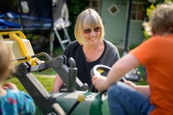 Woman with children down with gardening equipment