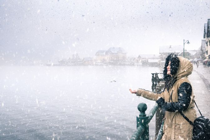 Woman enjoying the snow by a lake in Austria
