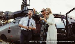 Beautiful women standing by helicopter with pilot 5kRpZQ