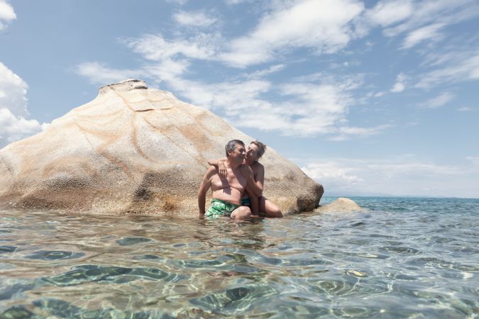 Loving couple hugging on island in water