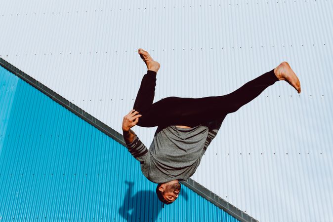 Trendy male flipping on street