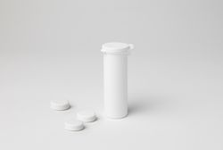Mockup of a closed elongated aspirin tube, white color, plastic material, with copyspace