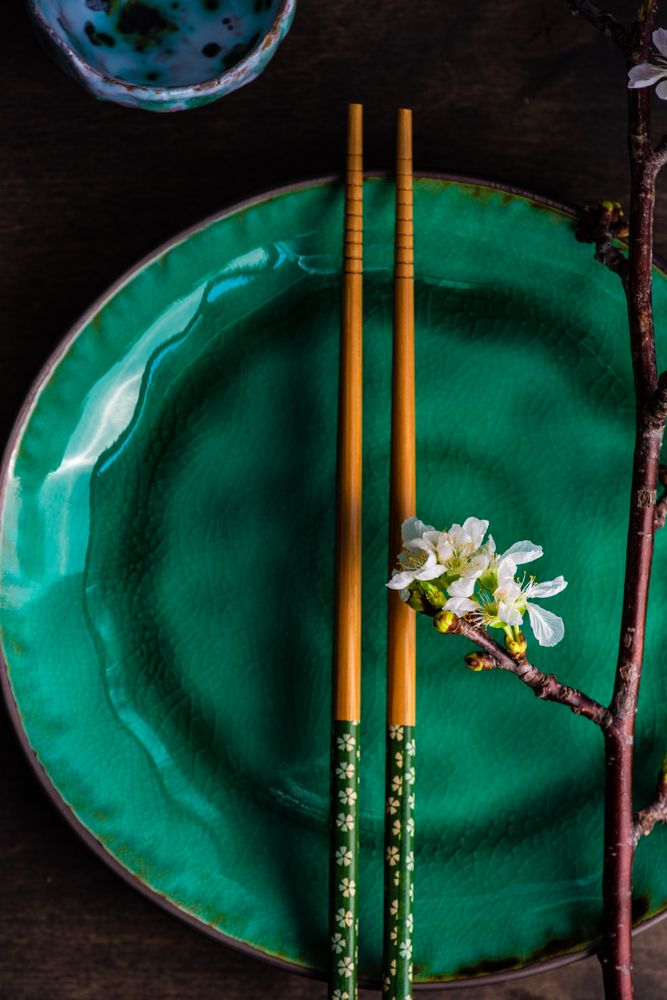 Asian table setting with cherry blossom and chopsticks