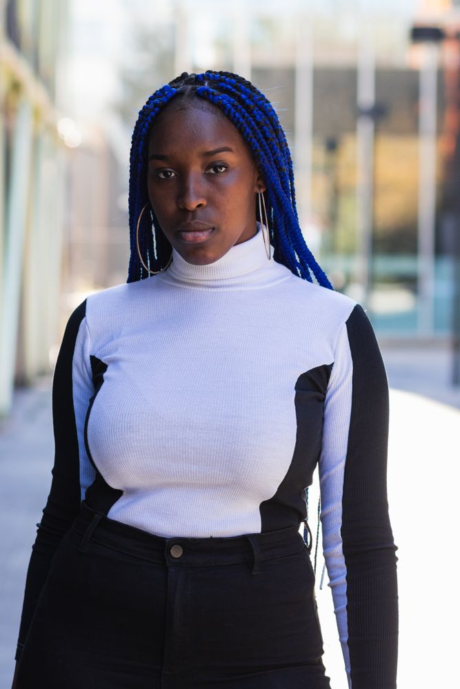 Thoughtful Black woman on street