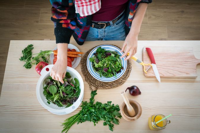 Woman preparing vegetable salad