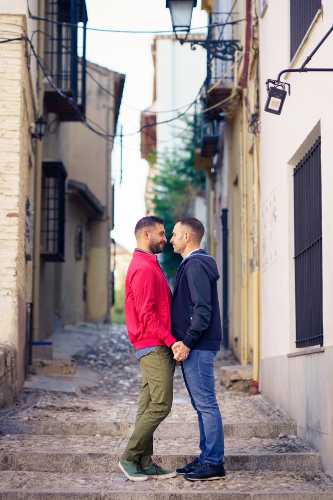 Cute male couple having romantic moment in European city