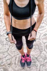 Woman posing with skipping rope in a park