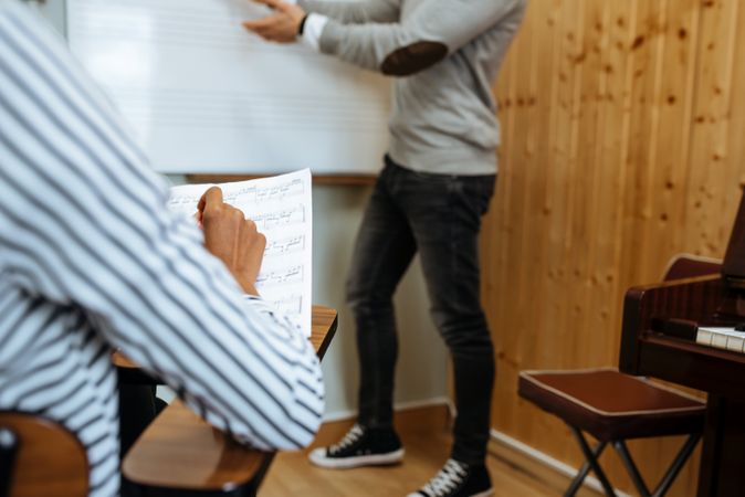 Man teaching woman music notes