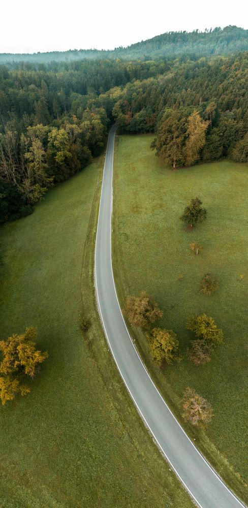 Drone aerial panorama with road passing through