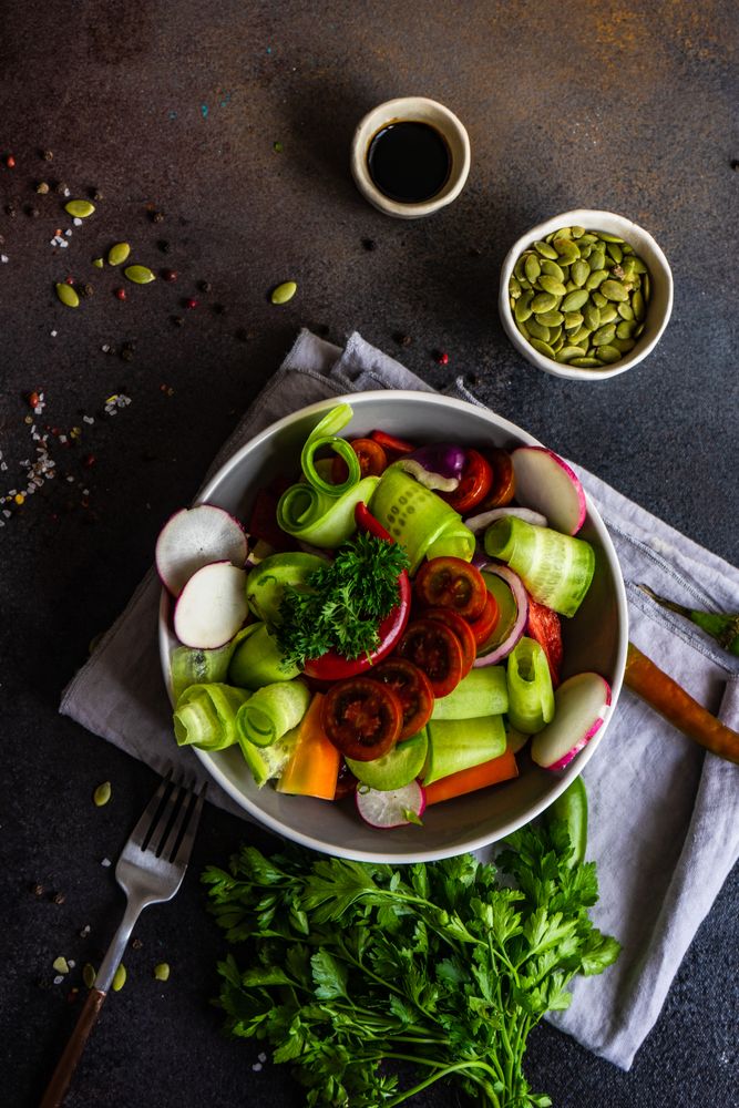 Top view of healthy raw salad with freshly chopped vegetables