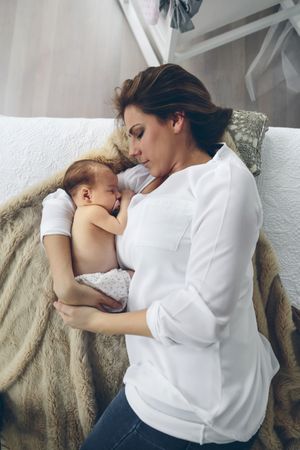 Mother hugging her newborn baby girl