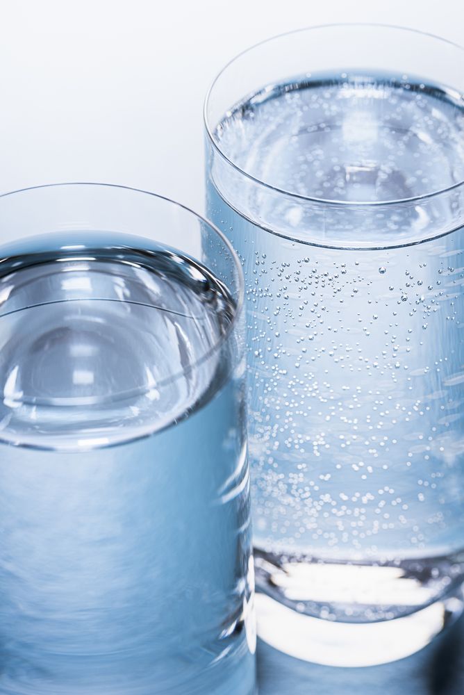 Two glasses of still and sparkling water