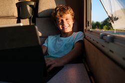 Delighted boy browsing netbook in RV