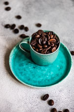 Coffee beans in teal cup