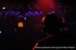 Dark photo of man performing at a club 5rBL75