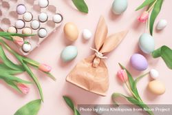 Top view of Easter eggs, tulips and paper bag in rabbit ear shapes 48kMZ5