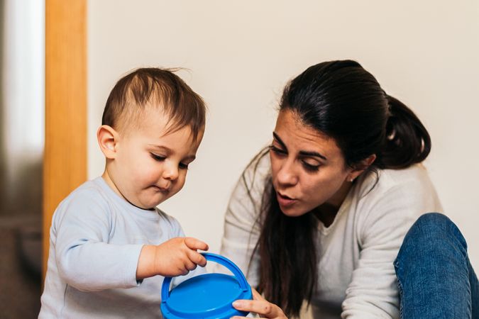 mother playing with her baby son at home