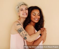 White woman and biracial woman standing together and smiling 5rmwP0