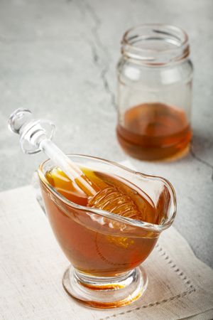 Honey in glass bowl on the table.