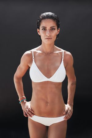 Portrait of muscular female model posing in lingerie