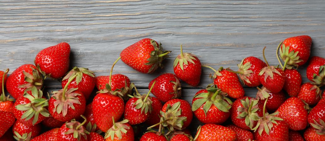 Tasty strawberry on wooden background, top view. Summer berry