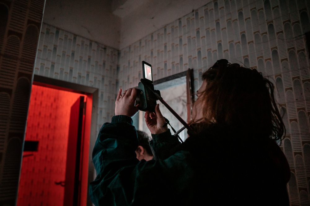 Woman shooting with camera indoor