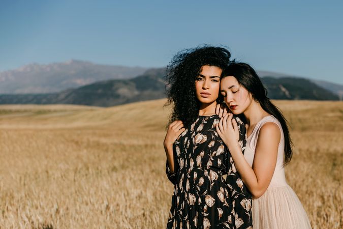 Female friends standing in field