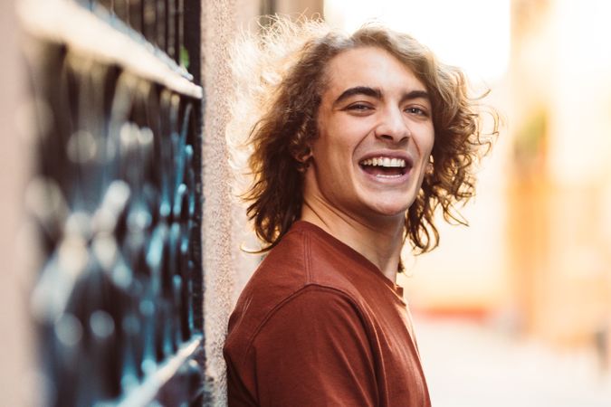 Positive handsome man smiling on street